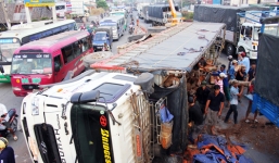 Xe tải lật ngang, 20 tấn gỗ lao xuống đường