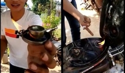 Hết hồn với cảnh thanh niên nghịch dại đốt lửa trên miệng bình xăng xe