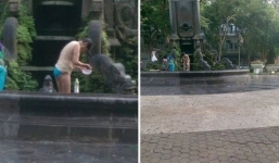 Xôn xao người phụ nữ tắm dưới đài phun nước ở Hà Nội