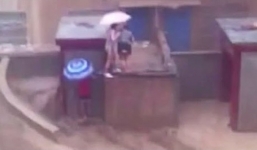 Video: Lũ dữ cuốn phăng hai người trên nóc nhà ở Trung Quốc
