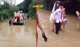 Chú rể cõng cô dâu vượt lũ trong ngày cưới gây xúc động mạnh
