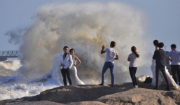 Hàng trăm cặp đôi đương đầu với siêu bão Dujuan để chụp ảnh cưới