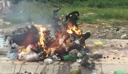 Giận vợ 'hờ' đi đánh bài, chồng đem xe máy ra bãi rác đốt