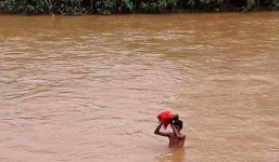 Bố nâng con gái 6 tháng tuổi vượt lũ đến trung tâm y tế