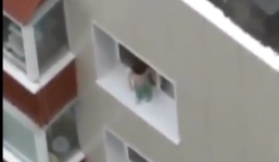 Thót tim bé trai trèo ra cửa sổ chung cư cao tầng chơi đùa
