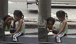 Xúc động trước hình ảnh cậu bé ăn xin đút cơm cho em 