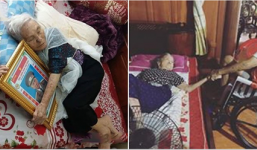 Xúc động hình ảnh cụ bà nằm ôm di ảnh chồng