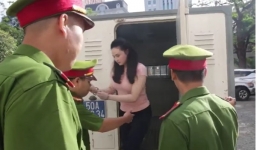 Hotgirl Ngọc Miu né tránh ống kính khi được áp giải đến phòng xử