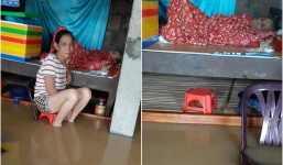 Hình ảnh cụ bà nằm trên giường trong khi nước lũ dâng cao khiến nhiều người xót xa