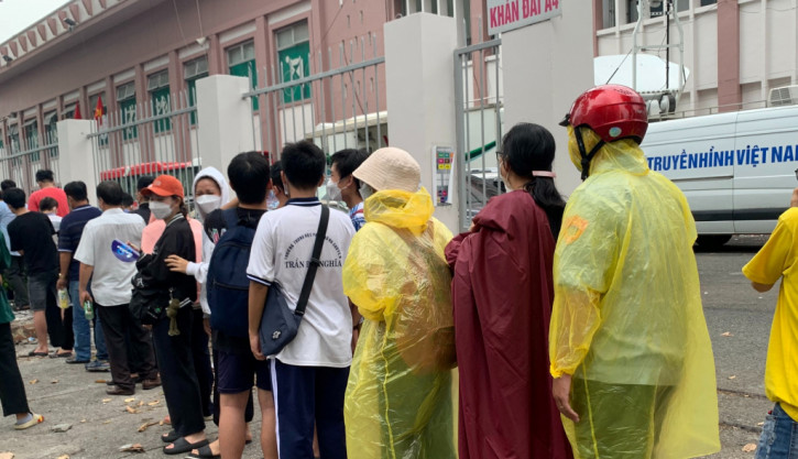 NHM đội mưa xếp hàng nhận vé. Ảnh: Internet