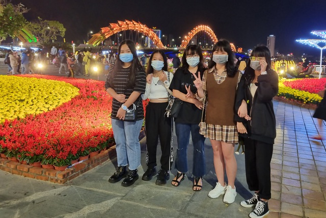 Người dân ở Đà Nẵng đổ về Cầu Rồng để chụp ảnh, chờ đợi thời khắc chuyển giao giữa năm cũ và năm mới. Ảnh: Dân Trí