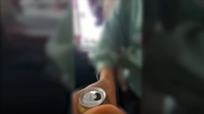 Hình ảnh một em học sinh cầm bia đến chúc cô giáo. Ảnh chụp từ clip