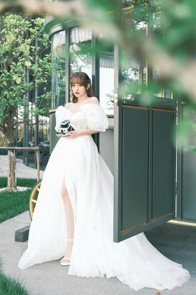 Thiết kế tay bồng trễ vai cùng phần xẻ tà tôn lên vóc dáng nuột nà của Trình Tiêu. Người đẹp lựa chọn giày cao gót trắng, quai mảnh để tạo nên sự đồng điệu